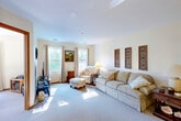 This well-appointed 2-bedroom, 1-bathroom residence at 50 Boulder Hill Pass in Montgomery, IL offers a thoughtfully designed single-floor layout with a welcoming hallway that connects all living spaces. The entry corridor features warm hardwood-style flooring and provides direct access to the main rooms, setting a clean and organized tone throughout.

The spacious living room is bathed in natural light from multiple windows overlooking lush outdoor greenery, with plush carpeting underfoot. It offers ample room for comfortable seating arrangements and everyday living. Adjacent to it is a cozy dining nook with its own window, ideal for casual meals.

The kitchen is equipped with abundant honey-toned wood cabinetry, a full suite of white appliances including a range and refrigerator, and durable hardwood-style flooring. It features an efficient U-shaped layout with generous counter space.

Both bedrooms are carpeted and comfortably sized, with the primary bedroom offering two closets and a window with natural light. The bathroom includes a wood-toned vanity with a white countertop, hardwood-style flooring, and a shower-tub combination. Notably, the unit includes six closets total, providing exceptional storage throughout. The neutral color palette and warm wood trim accents lend the space a cohesive, inviting character.