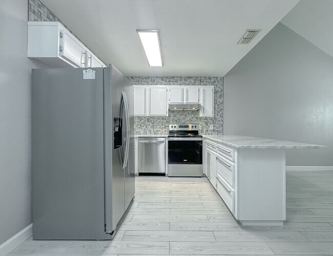 Building Photo - MODERN PARADISE! 2/2 w/ Marble Counters, Stainless Steel Appliances, Vaulted Ceilings, & More! Av...