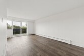 Located at 3905 Bathurst Street in Toronto's vibrant North York neighbourhood, this well-appointed one-bedroom, one-bathroom unit offers a clean, functional layout across a single floor. The interior is finished with warm hardwood-style flooring throughout, set against crisp white walls that lend a bright, airy feel to every room.

The living room is a generous, open space highlighted by large sliding glass doors and an adjacent window that flood the area with natural light and provide direct access to a private balcony overlooking lush tree canopy. Baseboard heating runs along the perimeter, ensuring comfort year-round.

The bedroom is a well-proportioned room featuring a large casement window with views of the surrounding neighbourhood's rooftops and greenery, along with baseboard heating for added comfort.

The bathroom is outfitted with classic white subway tile surrounding the full soaker tub and shower combination, paired with chrome fixtures — a timeless, clean aesthetic.

The unit's overall design is minimal and neutral, making it highly adaptable to a variety of interior styles. With its natural light, outdoor access, and tree-lined views, this Bathurst Street unit offers a calm and comfortable urban retreat in one of Toronto's well-connected residential corridors.