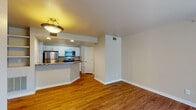 This single-story residence on Pace St in Longmont, Colorado, offers a well-organized layout with functional living spaces throughout. The open-concept living and dining area is finished with warm hardwood flooring and features a tile-surround fireplace as a central focal point. A large window and sliding glass door allow natural light to fill the space while providing outdoor views of surrounding greenery.

The kitchen is designed for practicality and style, featuring white cabinetry, granite-toned countertops, and a full suite of stainless steel appliances including a refrigerator, electric range, and over-the-range microwave. A raised breakfast bar separates the kitchen from the living area, creating an open yet defined space for casual dining. Built-in shelving near the living area adds additional storage and display options.

The bedrooms are carpeted for comfort, with one featuring access to a bathroom and a walk-in closet area, offering added convenience. The bathroom includes a tiled tub-shower combination with a classic white tile surround accented by a dark decorative tile border. Neutral wall tones and consistent finishes throughout create a cohesive and welcoming atmosphere across the entire residence.