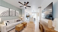 Located at 35155 N Thompson Rd in Queen Creek, Arizona, this thoughtfully designed one-bedroom, one-bathroom residence makes excellent use of its compact footprint across a single floor. The open-concept living and kitchen area serves as the heart of the home, featuring light wood-look flooring, crisp white walls, and a distinctive sage green board-and-batten accent wall in the living space. A ceiling fan overhead and large windows with plantation blinds bring in ample natural light, creating a bright and airy atmosphere.

The kitchen is well-appointed with white shaker cabinets, a dark tile backsplash, granite countertops, a central island with bar seating, and a full suite of stainless steel appliances. Pendant lighting and a sliding glass door further enhance the space.

The bedroom is a serene retreat with multiple windows, a ceiling fan, and generous closet storage. The full bathroom showcases a granite-topped vanity with white shaker cabinetry, black matte fixtures, a framed mirror, and a tub-shower combination. A dedicated laundry room with a full-size washer and dryer adds everyday convenience, rounding out this well-equipped and stylishly finished residence.