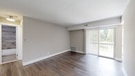 Located at 225 Echelon Rd in Voorhees, NJ, this single-floor, three-bedroom, one-bathroom residence offers a well-organized layout across a compact yet functional footprint. The living room serves as the heart of the home, showcasing rich dark hardwood-style flooring, neutral gray walls, and a sliding glass door with vertical blinds that invites natural light and provides access to an outdoor balcony with greenery views. The kitchen is thoughtfully updated with stainless steel appliances — including a gas range, over-the-range microwave, and full-size refrigerator — complemented by white upper cabinetry, wood-toned lower cabinets, light countertops, and a distinctive blue subway tile backsplash. Connecting hallways with matching hardwood-style floors lead to the three bedrooms, two of which feature hardwood-style flooring and ceiling fans or large windows for added comfort, while the primary bedroom offers a walk-in closet and plush carpeting. The full bathroom is finished with a soaking tub, wood-look tile surround, and clean white fixtures, adding a spa-like touch. Throughout the residence, a consistent neutral color palette and modern finishes create a cohesive and welcoming ambiance.