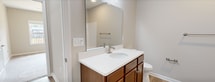 This 680-square-foot, one-bedroom, one-bathroom apartment at 23 Encanto Ln, Unit 105 in Rustburg, VA offers a well-organized single-floor layout encompassing a kitchen, bedroom, bathroom, closet, and hallway. The open living area features light-toned luxury vinyl plank flooring, neutral wall tones, and a ceiling fan, with large windows that invite abundant natural light and outdoor views of the surrounding community. The kitchen is well-appointed with rich medium-toned wood cabinetry, white countertops, a double-basin sink, and a full suite of stainless steel appliances including a range, microwave, dishwasher, and refrigerator — all set atop matching LVP flooring. The 140-square-foot primary bedroom is carpeted for comfort and includes a ceiling fan, a generously sized window with outdoor views, and access to a dedicated closet. The bathroom features warm wood cabinetry with a white countertop vanity, a large mirror, a soaking tub, and LVP flooring that ties cohesively to the rest of the unit. Consistent neutral finishes, clean white trim, and a practical floor plan make this apartment a comfortable and functional living space.