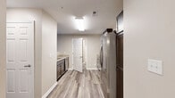 Located at 2140 Old Hundred Road in Midlothian, Virginia, this single-floor 2-bedroom, 2-bathroom residence offers a practical and modern layout designed for comfortable living. The open-concept living, dining, and kitchen area serves as the heart of the home, featuring warm neutral-toned walls and durable wood-look plank flooring that flows throughout the main living spaces. The kitchen is equipped with dark cabinetry, stainless steel appliances including a full-size refrigerator, and ample counter space, with a convenient pass-through that connects to the living area.

The spacious primary bedroom receives natural light through a large window with outdoor views, and is complemented by its own en-suite bathroom featuring stone-look tile flooring, a dark wood vanity with a white countertop, and a full soaking tub with a clean white surround. The second bedroom is similarly sized, also with a window overlooking the exterior, and has access to a second bathroom with matching finishes.

Four closets throughout the unit provide generous storage, and a dedicated laundry area adds everyday convenience. Clean white six-panel doors, neutral paint tones, and consistent modern finishes give the entire space a cohesive and well-maintained feel.