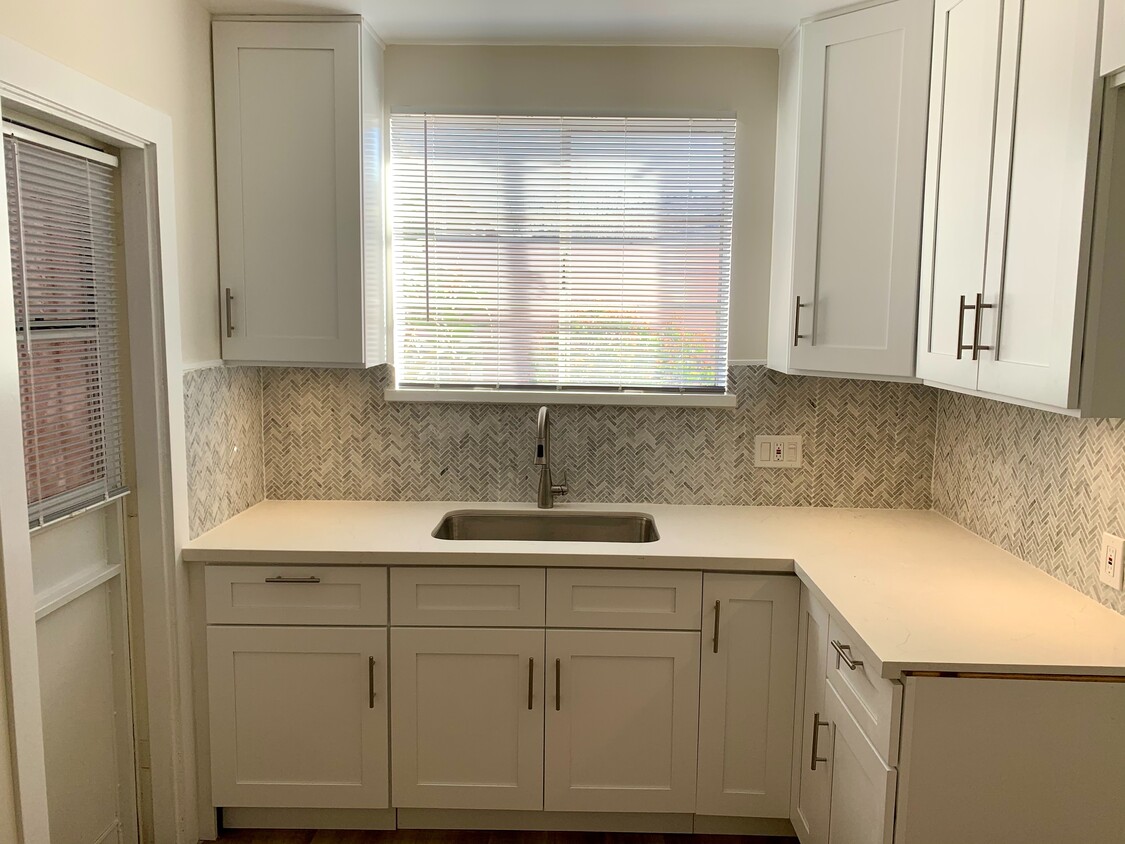 New kitchen with beautiful herringbone pattern backsplash, new cabinets - 4153 Marlton Ave