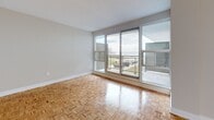 Located at 33 Ontario St in Kingston, Ontario, this well-appointed 1-bedroom, 1-bathroom unit offers a thoughtfully designed layout across a single floor. Warm parquet wood flooring flows throughout the living, dining, and bedroom areas, lending the space a classic yet timeless character.

The galley-style kitchen is efficiently laid out with crisp white shaker cabinetry, grey countertops, a white subway tile backsplash, and stainless steel appliances including a dishwasher, stove, and built-in microwave. Light-toned tile flooring completes the clean, functional aesthetic.

The spacious living room is a standout feature, bathed in natural light through a large wall of sliding glass doors that open to a balcony. The outdoor views are exceptional, overlooking a waterfront setting with open skies — a rare and desirable feature. Baseboard heating runs along the perimeter, ensuring comfort year-round.

The well-sized bedroom includes a sliding window with city views and direct access to two closets, providing ample storage. The full bathroom is finished with white subway tile surrounding the tub-shower combination, a grey countertop vanity with a vessel sink, a mirrored medicine cabinet, and tile flooring throughout. The unit also benefits from an entry foyer that creates a clear transition between the kitchen and living areas.
