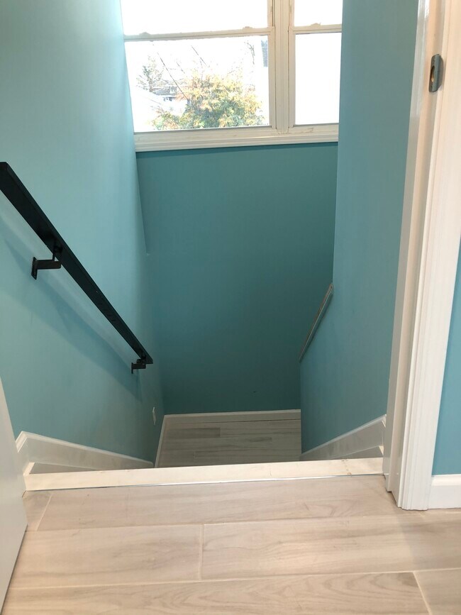 Turnaround stairwell to apartment, tiled landing - 409 Brinley Ave