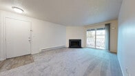 Located at 2211 S 96th St in Tacoma, Washington, this single-floor unit offers a well-organized layout designed for comfortable everyday living. The generously sized living room is a standout space, anchored by a classic stone-surround fireplace and a sliding glass door that opens to a private balcony, allowing natural light to fill the room. Plush wall-to-wall carpeting and baseboard heating add warmth and comfort to the living area. The kitchen is bright and functional, featuring white cabinetry with ample storage, light countertops, a stainless steel sink, and white appliances including a dishwasher and range. Wood-look flooring in the kitchen provides a clean, practical surface. The bedrooms are carpeted and well-proportioned, with windows that bring in natural light and views of the surrounding area. The bathroom is finished with wood-look flooring, white cabinetry, a single vanity with a light countertop, a large mirror, and a full tub-shower combination. A hallway connects the main living areas to the bedrooms, with textured ceilings consistent throughout the unit. The overall design is clean and neutral, offering a versatile canvas well-suited to a variety of living arrangements.