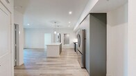 Located at 800 N Front St in Burbank, CA, this well-appointed 2-bedroom, 2-bathroom residence offers a thoughtfully designed single-level layout with modern finishes throughout. Light wood-tone flooring runs continuously through the living areas and bedrooms, complementing the clean, neutral color palette that defines the space.

The kitchen is a standout feature, showcasing two-tone cabinetry — muted sage-green lower cabinets paired with light wood upper cabinets — alongside a white quartz countertop, subway tile backsplash, stainless steel appliances including a gas range and French door refrigerator, and a kitchen island with pendant lighting. The layout flows openly into the living area, which connects to a private balcony with outdoor views.

The spacious primary bedroom features abundant natural light from a large window and access to a generous walk-in closet with multi-rod shelving. The en-suite bathroom includes large-format tile, a glass-enclosed shower, and built-in shelving. The second bedroom also includes a walk-in closet, while the second bathroom offers a tiled tub-shower combination, sage cabinetry, and a sleek vanity with a matte black faucet. The overall ambiance is clean, contemporary, and move-in ready.