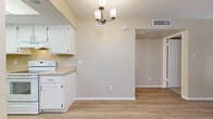 Located at 5350 E Taylor St in Phoenix, Arizona, this single-floor home offers four bedrooms and two bathrooms within a practical and well-organized layout. The interior features a neutral, warm color palette with beige tones throughout, creating a cohesive and inviting atmosphere.

The kitchen is designed with efficiency in mind, featuring white cabinetry, light countertops, a full suite of white appliances including a refrigerator and electric range, and light wood-look flooring. A window above the sink brings in natural light. Adjacent to the kitchen, a dining area is accented by a classic brass chandelier, continuing the light flooring that extends into the living area.

The living room is a generous open space with light wood-look flooring and a sliding glass door that provides direct outdoor access and fills the room with natural light and garden views.

The bedrooms feature plush carpeting and warm neutral walls. The primary bedroom includes a sliding glass door with outdoor views, adding brightness and a sense of openness. The remaining bedrooms offer comfortable, carpeted spaces.

Both bathrooms are finished with white vanity cabinetry, light countertops, and wood-look flooring. One bathroom features a shower/tub combination, while the other is appointed as a half bath with a mirrored medicine cabinet. A hallway and closet complete the functional floor plan.