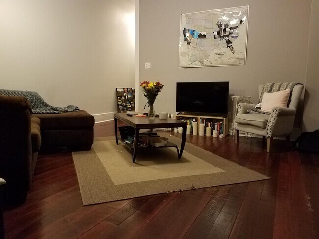 Livingroom has refinished hardwood floors , ten foot ceilings and canned lighting! - 124 N Oriental St