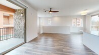 Located at 141 36th St in Los Alamos, NM, this two-story home offers a well-designed layout across two floors, with the majority of the living space situated on the main level. The home includes two bedrooms, two bathrooms, an attached garage, and two closets.

The main living area is bright and open, featuring light hardwood-style flooring, recessed lighting, and a ceiling fan. Multiple windows allow natural light to fill the space. A stone accent wall near the entry adds a distinctive architectural touch. The open-concept kitchen is a standout feature, equipped with stainless steel appliances, light wood cabinetry extending to the ceiling, granite countertops, a central island, pendant lighting, and track lighting overhead.

Both bathrooms are finished consistently, featuring wood-toned vanities with granite countertops and hardwood-style flooring. One bathroom includes a glass-enclosed walk-in shower, while the other offers a full tub-shower combination.

The bedrooms are carpeted and receive natural light through windows with blinds. The primary bedroom includes a ceiling fan. Both bedrooms offer access to dedicated closets.

The attached garage provides concrete flooring and direct interior access, offering practical storage and parking.