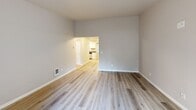 Located at 6200 Soundview Dr in Gig Harbor, WA, this single-story, 4-bedroom, 2-bathroom home offers a functional and well-appointed layout with a clean, modern aesthetic. Light wood-style flooring runs throughout the main living areas, contributing to a bright and cohesive feel. The living room is a generously sized, open space with neutral gray walls, wall heating units, and seamless flow into the rest of the home. The kitchen is a standout feature, equipped with white shaker-style cabinetry, gray countertops, stainless steel appliances including a range, microwave, refrigerator, and dishwasher, and a large window overlooking lush greenery outside. The four bedrooms are finished with soft carpet, neutral tones, and ample closet space, providing comfortable and versatile living options. The primary bedroom offers a well-proportioned retreat. Both bathrooms are finished with light wood-style flooring, white surrounds on the tub/shower combos, gray countertops, and white cabinetry, delivering a consistent and updated look. A hallway connects the rooms efficiently, and multiple closets provide generous storage throughout. The surrounding tree-lined setting is visible from interior windows, adding a touch of natural scenery to the home.