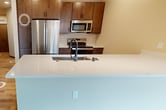 This contemporary 3-bedroom, 2-bathroom apartment in Madison, Wisconsin offers 1060 square feet of thoughtfully designed living space. The single-floor layout promotes easy navigation and efficient use of space. The primary bedroom, measuring 150 square feet, provides ample room for comfort and privacy.

Throughout the apartment, warm-toned hardwood floors create a cohesive and inviting atmosphere. Large windows in the bedrooms and living areas flood the space with natural light, enhancing the sense of openness. The kitchen showcases modern appliances and a sleek design, with a peninsula that seamlessly connects to the living area, perfect for entertaining.

The bathrooms feature clean lines and contemporary fixtures, including vanities with ample storage and glass-enclosed showers. Built-in closets and storage solutions help maximize the available space. The open-concept design of the main living area creates a spacious feel, ideal for both relaxation and social gatherings.

Located at 545 W Washington Ave, this apartment offers the convenience of urban living in the heart of Madison. The property's modern aesthetic, functional layout, and attention to detail make it an attractive option for those seeking a contemporary living space in a vibrant city setting.