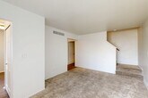 Located at 16651 E 12 Mile Rd in Roseville, Michigan, this multi-level home spans three floors and offers a practical, well-organized layout across its living spaces. The main level features a spacious carpeted living room with staircase access, along with a combined dining and kitchen area. The kitchen is outfitted with rich dark wood cabinetry, granite-style countertops, stainless steel appliances including a gas range and refrigerator, and durable wood-look flooring — providing both functionality and style. Two full bathrooms serve the home, with one featuring a grab bar and granite countertop details. The upper level houses two carpeted bedrooms, each benefiting from natural light through windows fitted with vertical blinds. The primary bedroom includes a double sliding-door closet and direct access to the hallway, while the second bedroom offers a similarly bright and functional layout. Throughout the home, five closets provide generous storage. The basement level presents an open, unfinished space with a utility/laundry area, exposed structural beams, and concrete flooring — offering significant potential for additional storage or future finishing. The home's clean, neutral palette and multi-floor design make it a versatile and functional residence.