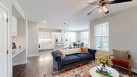 Located at Wildwood Park in Richmond, TX, this single-story, 2-bedroom, 2-bathroom home offers a thoughtfully designed layout that balances comfort and functionality. Rich hardwood flooring flows throughout, complementing the neutral, warm-toned walls that create a cohesive and inviting atmosphere.

The open-concept living area is anchored by a ceiling fan and large windows that bathe the space in natural light, with views of lush greenery outside. The kitchen features white shaker-style cabinetry, granite countertops, a classic subway tile backsplash, and stainless steel appliances, providing both style and practicality. Adjacent to the kitchen, the dining area is framed by corner windows dressed with sheer curtains and wood blinds, creating a bright and airy setting ideal for everyday meals.

Both bedrooms are generously proportioned, each equipped with ceiling fans and windows overlooking the surrounding landscape. The primary bedroom connects to a well-finished bathroom featuring granite countertops, white cabinetry, a large mirror, and a bathtub. Each bedroom also benefits from dedicated closet space.

A private balcony overlooks a beautifully landscaped courtyard with mature trees, walking paths, and open green space, offering a peaceful outdoor retreat. This home combines clean finishes with a warm, livable design throughout.