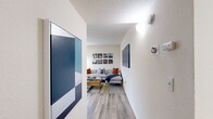 The Redwood floor plan in Citrus Heights, CA offers a well-designed single-level layout with one bedroom, one bathroom, and a thoughtfully organized collection of living spaces. Light wood-style flooring flows throughout, creating a cohesive and contemporary feel from room to room.

The welcoming hallway leads into a bright, open living room featuring a ceiling fan, a large window that invites natural light, and ample space for comfortable seating arrangements. Adjacent to the living room, the dining area provides a natural transition to the kitchen, which stands out with crisp white cabinetry, quartz-style countertops, stainless steel appliances — including a refrigerator, range, and dishwasher — and a deep single-basin sink beneath a window.

The spacious bedroom offers a serene retreat, highlighted by a distinctive decorative accent wall, a generous window with outdoor views of lush greenery, and access to two closets for abundant storage. The full bathroom features a white vanity with modern hardware, a tub/shower combination, and wood-style flooring that complements the rest of the home.

A dedicated in-unit laundry room with a full-size washer and dryer adds everyday convenience, while a private patio extends the living space outdoors. The unit is surrounded by mature trees, enhancing the sense of privacy and natural setting.