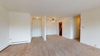 Located at 7825 S Scepter Dr in Franklin, Wisconsin, this single-floor residence offers a well-organized layout with a comfortable, functional design throughout. The generously sized living area is finished with neutral-toned carpeting and features a ceiling fan, baseboard heating, and a large sliding glass door that opens to a private balcony, filling the space with natural light and providing pleasant outdoor views. A second window adds to the bright, airy feel of the room. The kitchen is well-appointed with warm oak cabinetry extending to the ceiling for ample storage, dark granite-style countertops, hardwood-style flooring, and a full suite of stainless steel appliances including a gas range, dishwasher, and refrigerator. The bedroom is carpeted and features a window with blinds and baseboard heating for year-round comfort. Two bathrooms serve the unit: a full bath with a tiled tub-shower combination, oak vanity, and hardwood-style flooring, and a second bath with a vanity and mirrored medicine cabinet. Generous closet space is found near the entryway, and baseboard heating is present throughout. The overall ambiance is clean, bright, and move-in ready.