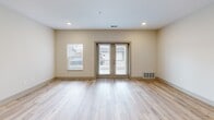 Located at 267 Seminole Rd in Norton Shores, Michigan, this single-story, one-bedroom, one-bathroom unit offers a thoughtfully designed layout that maximizes its compact footprint. The open-concept kitchen and living area serves as the heart of the unit, where light hardwood-style flooring flows throughout, creating a cohesive and bright atmosphere. Recessed lighting illuminates the space, complemented by natural light streaming in through windows and a set of glass French doors in the living room that provide outdoor access and additional brightness.

The kitchen is a standout feature, equipped with medium-toned wood cabinetry, granite countertops, a central island with a built-in sink, stainless steel appliances including a gas range, microwave, and refrigerator, and pendant lighting overhead. A dedicated range hood adds both function and visual interest.

The bedroom offers a comfortable, carpeted retreat with a double-door closet and a window fitted with vertical blinds for light control. The bathroom is finished with warm wood-tone cabinetry topped with granite, light hardwood-style flooring, and a full tub-shower combination with a curved curtain rod and brushed nickel fixtures. Neutral tones throughout the unit create a clean, modern aesthetic.