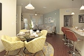 The Osprey is a well-appointed 2-bedroom, 2-bathroom residence spread across a single floor, offering a comfortable and functional layout ideal for everyday living. The open-concept living and dining area serves as the heart of the home, featuring rich hardwood-style flooring, ample room for both a dining set and a full living room arrangement, and a bright, inviting atmosphere. The kitchen is positioned conveniently adjacent to the dining space, providing easy access for entertaining and daily use. The primary bedroom is generously sized, offering space for a full bedroom suite, and is complemented by its own dedicated bathroom. The second bedroom is equally well-proportioned, making it suitable as a guest room, home office, or personal retreat, with a second full bathroom nearby. Throughout the residence, neutral tones on the walls and flooring create a versatile backdrop that adapts easily to a variety of décor styles. The layout flows naturally from room to room, maximizing usability and comfort. With its spacious floor plan, cohesive design, and practical configuration, the Osprey delivers a balanced living experience suited to a wide range of lifestyles.