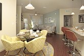 The Osprey is a well-appointed 2-bedroom, 2-bathroom residence spread across a single floor, offering a comfortable and functional layout ideal for everyday living. The open-concept living and dining area serves as the heart of the home, featuring rich hardwood-style flooring, ample room for both a dining set and a full living room arrangement, and a bright, inviting atmosphere. The kitchen is positioned conveniently adjacent to the dining space, providing easy access for entertaining and daily use. The primary bedroom is generously sized, offering space for a full bedroom suite, and is complemented by its own dedicated bathroom. The second bedroom is equally well-proportioned, making it suitable as a guest room, home office, or personal retreat, with a second full bathroom nearby. Throughout the residence, neutral tones on the walls and flooring create a versatile backdrop that adapts easily to a variety of décor styles. The layout flows naturally from room to room, maximizing usability and comfort. With its spacious floor plan, cohesive design, and practical configuration, the Osprey delivers a balanced living experience suited to a wide range of lifestyles.