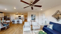 This well-appointed single-story home in Pensacola, Florida offers a thoughtfully designed open-concept floor plan with four bedrooms and two full bathrooms. Wood-look flooring runs throughout the home, creating a cohesive and clean aesthetic from room to room.

The living area is generously sized and features recessed lighting and a ceiling fan, flowing seamlessly into the dining area and kitchen. The kitchen is outfitted with white shaker-style cabinetry, granite countertops, a breakfast bar, and a full suite of stainless steel appliances, including a refrigerator, range, and microwave. A dedicated dining space accommodates a full dining table and receives natural light through a nearby exterior door.

The bedrooms are well-proportioned and fitted with ceiling fans and ample closet space. One room serves effectively as a home office, featuring a large window with outdoor views. The two bathrooms include granite-topped vanities and tub-shower combinations with tiled surrounds. A dedicated interior laundry room provides added convenience with full-size washer and dryer hookups and overhead shelving.

A wide, light-filled hallway connects the main living spaces to the private bedrooms, adding to the home's open and airy feel. The neutral color palette and consistent finishes throughout create a clean, move-in-ready environment.