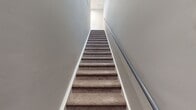 This contemporary apartment at Lenox Farms offers a spacious 1120 square feet of living area on a single floor. The layout includes three bedrooms, two full bathrooms, a kitchen, living room, and two hallways. The primary bedroom is generously sized at 170 square feet, providing ample space for comfort.

The interior design showcases a modern aesthetic with a neutral color palette. Light grey walls complement the wood-look flooring that runs consistently throughout the apartment, creating a cohesive and open feel. Large windows in the living area and bedrooms allow for abundant natural light, enhancing the sense of spaciousness.

The kitchen features white cabinetry, stainless steel appliances, and a functional galley-style layout with an arched entryway. Both bathrooms are updated with modern fixtures, including a vanity with ample storage in one and a walk-in shower in the other. The living room boasts an arched entryway, adding architectural interest.

Storage solutions are evident throughout, with a walk-in closet visible in one of the images. The apartment's design prioritizes functionality without compromising on style, making it an ideal living space for those seeking a contemporary home with a practical layout.