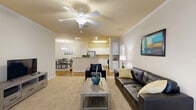 Located at 4910 N Monroe St in Tallahassee, FL, this well-appointed 2-bedroom, 2-bathroom unit offers a comfortable and functional single-floor layout. The open-concept living area greets you with warm neutral tones, plush carpeting, crown molding, and a ceiling fan, creating a welcoming atmosphere. Large windows invite abundant natural light throughout. The living space flows seamlessly into a dedicated dining area, accented by a stylish chandelier and hardwood-style flooring, and further into a well-equipped kitchen featuring white cabinetry, light countertops, stainless steel appliances, and a convenient pantry for additional storage. The generously sized primary bedroom includes a ceiling fan and a spacious walk-in closet with wire shelving. The second bedroom is equally comfortable, also outfitted with carpeting and a ceiling fan. Both bathrooms feature tile flooring, white vanity cabinetry, and tub-shower combinations. A dedicated in-unit laundry room with washer and dryer hookups adds everyday convenience. Four closets throughout the unit ensure ample storage. A private patio completes the layout, offering an outdoor retreat. This unit provides a well-rounded combination of comfort, storage, and practicality in a residential Tallahassee location.