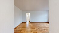 This 510 square foot apartment in St. Louis Park, MN offers a well-designed living space with two bedrooms and one bathroom. The unit features beautiful hardwood floors throughout, creating a warm and inviting atmosphere. Large windows in each room allow for abundant natural light, enhancing the sense of space.

The primary bedroom, measuring 120 square feet, provides a comfortable retreat. The second bedroom, while smaller, offers versatility as a guest room or home office. The single bathroom is efficiently designed with white tile, a bathtub-shower combination, and a window for ventilation.

The living area is open and bright, with smooth white walls that reflect light and create a sense of spaciousness. A hallway connects the various rooms, ensuring a logical flow throughout the apartment. The kitchen, though compact, is functional with white cabinetry, a refrigerator, and a stove, making efficient use of the available space.

Heating is provided by classic radiators, adding a touch of character to the rooms. The apartment's layout maximizes the use of its 510 square feet, offering a surprisingly comfortable living space despite its modest size. The property's location at 3551 Huntington Ave in St. Louis Park provides convenient access to urban amenities while maintaining a residential feel.