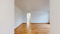 This 510 square foot apartment in St. Louis Park, MN offers a well-designed living space with two bedrooms and one bathroom. The unit features beautiful hardwood floors throughout, creating a warm and inviting atmosphere. Large windows in each room allow for abundant natural light, enhancing the sense of space.

The primary bedroom, measuring 120 square feet, provides a comfortable retreat. The second bedroom, while smaller, offers versatility as a guest room or home office. The single bathroom is efficiently designed with white tile, a bathtub-shower combination, and a window for ventilation.

The living area is open and bright, with smooth white walls that reflect light and create a sense of spaciousness. A hallway connects the various rooms, ensuring a logical flow throughout the apartment. The kitchen, though compact, is functional with white cabinetry, a refrigerator, and a stove, making efficient use of the available space.

Heating is provided by classic radiators, adding a touch of character to the rooms. The apartment's layout maximizes the use of its 510 square feet, offering a surprisingly comfortable living space despite its modest size. The property's location at 3551 Huntington Ave in St. Louis Park provides convenient access to urban amenities while maintaining a residential feel.