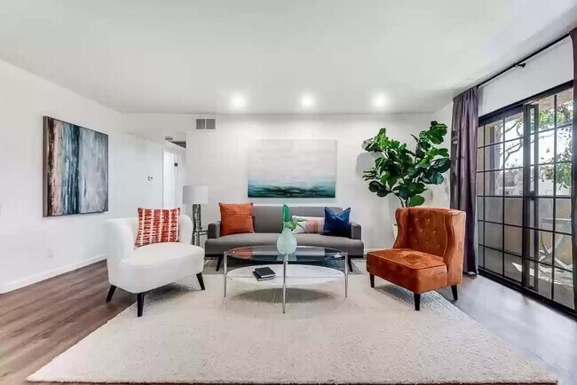 Living room with hardwood vinyl flooring (if furnished) with recessed lights and black-out curtains - 10220 De Soto Ave