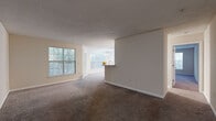 This single-floor residence offers a well-planned layout with a comfortable, functional flow throughout. The living and dining area is generously proportioned, featuring plush carpeting, neutral-toned walls, and large windows that bring in abundant natural light while offering views of surrounding greenery. A textured ceiling adds subtle character to the space, and the open sightlines toward the kitchen create a cohesive, connected atmosphere.

The kitchen is a standout feature, outfitted with white shaker-style cabinetry, marble-look countertops, a tile backsplash, and wood-look flooring. Black appliances, including a refrigerator, range, and dishwasher, provide a clean contrast against the bright cabinetry. A peninsula with additional counter space connects the kitchen to the living area, making it practical for both cooking and casual dining.

The bedrooms are carpeted and well-sized, each receiving natural light through windows with outdoor views. Closet storage is included, with at least one bedroom featuring a sliding-door closet. The bathrooms are finished with marble-look countertops, modern fixtures, and clean, neutral tones, with one bathroom including a soaking tub. Overall, the space presents a bright, refreshed interior with consistent finishes throughout.