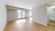Located at 1321 Veterans Hwy in Bristol, Pennsylvania, this two-bedroom, one-bathroom residence offers a clean, modern aesthetic across a single floor. Light hardwood flooring flows consistently throughout every room, complementing the soft neutral gray and white walls that create a bright, cohesive atmosphere.

The spacious living room is a standout feature, offering generous open floor space and multiple windows fitted with horizontal blinds that allow ample natural light to filter in. A front entry door opens directly into this area, which also connects to the kitchen. The kitchen is equipped with white cabinetry, countertops, and full appliances, providing functional workspace in a compact layout.

The primary bedroom is a well-proportioned room featuring natural light from a corner window and a built-in closet with double doors for storage. The second bedroom similarly benefits from a large window and includes a closet, making it equally well-suited as a guest room or home office.

The bathroom is finished with a clean, all-white tub and shower surround featuring built-in shelving niches, paired with brushed nickel fixtures and a standard toilet — all in a tidy, functional layout.

Overall, this residence presents a well-maintained, move-in-ready interior with consistent finishes and practical room configurations throughout.
