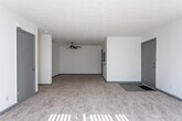 Located at 730 Beresford Cir in Stone Mountain, GA, this single-floor residence offers a practical and well-organized layout throughout. The kitchen is a standout feature, equipped with gray shaker-style cabinetry, white subway tile backsplash, light wood-look vinyl flooring, a double sink, and black appliances including a refrigerator, range with hood, and dishwasher — providing ample storage and counter space for everyday cooking. Adjacent to the kitchen, the living area is generously sized, finished with neutral carpet and a textured ceiling, with access to a carpeted hallway connecting the rest of the home. The bedrooms are comfortable and well-lit, each featuring plush carpeting, textured ceilings, windows with blinds that allow natural light, and bi-fold closet doors with built-in shelving and hanging rods. The bathrooms include a vanity bathroom with a marble-style countertop, an integrated sink, brushed nickel faucet, and a framed mirror, as well as a full bathroom with wood-look tile flooring, a vanity with cabinetry, and a shower/tub combination. Throughout the space, a consistent neutral color palette of whites and grays creates a clean, cohesive aesthetic.