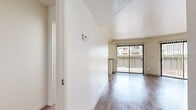 This 600 square foot, single-story apartment offers a thoughtful layout that maximizes space efficiency. The open-plan living and dining area is adorned with sleek wood-look flooring and benefits from ample natural light through large sliding glass doors. A focal point of the room is a built-in fireplace, adding both warmth and character.

The galley kitchen boasts light wood cabinetry, contrasting dark countertops, and modern appliances, creating a functional cooking space. The bathroom features a tub-shower combination, a single vanity with storage, and continues the apartment's contemporary aesthetic.

The bedroom, measuring 130 square feet, includes a spacious closet and is carpeted for comfort. An in-unit laundry room with full-sized washer and dryer adds convenience to daily living.

Throughout the apartment, vertical blinds offer privacy and light control. The neutral color palette and clean lines create a canvas for personal style, while the overall design caters to modern, low-maintenance living in an urban setting.