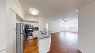 This contemporary 980 square foot apartment offers a blend of style and functionality. The heart of the home is a renovated kitchen, boasting sleek stainless steel appliances, elegant granite countertops, and modern white cabinetry. A tiled backsplash adds a touch of sophistication.

The living areas showcase beautiful hardwood flooring, creating a warm and inviting atmosphere. Large windows in the living room and bedrooms allow for ample natural light, enhancing the sense of space. The primary bedroom, measuring 140 square feet, provides a cozy retreat.

Both bedrooms feature plush carpeting for comfort underfoot. The apartment includes two full bathrooms, one with a spacious bathtub. Convenience is key with an in-unit laundry room equipped with a washer and dryer.

The floor plan is efficiently designed, with a hallway connecting the various rooms. Two closets offer additional storage space. Throughout the apartment, ceiling fans provide air circulation and ambient lighting.

This well-appointed apartment combines modern amenities with a practical layout, perfect for comfortable urban living.