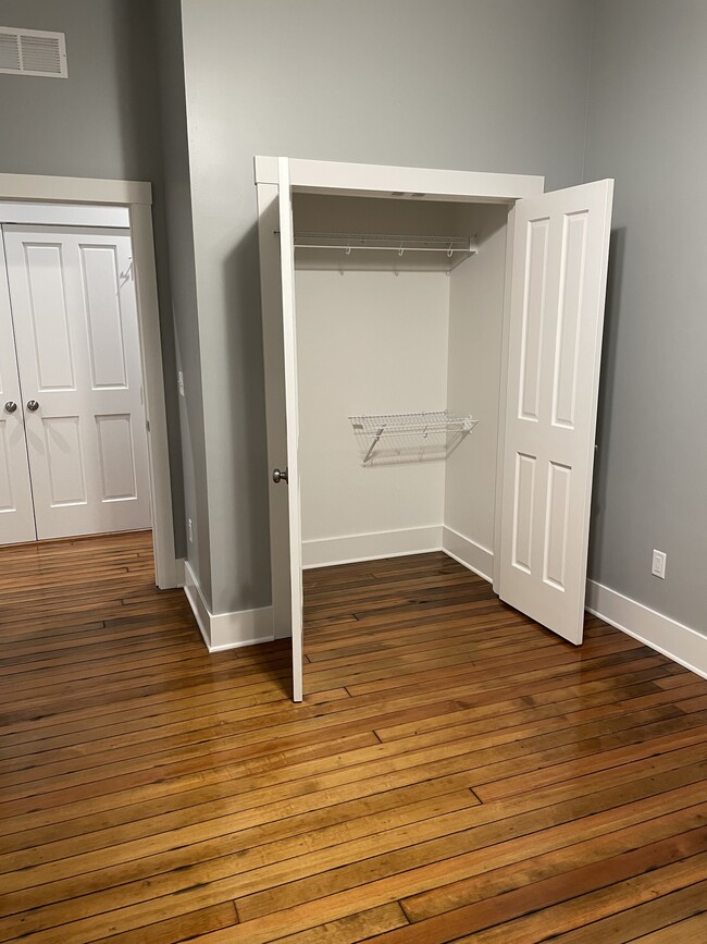 Walk-in closet of first bedroom. - 204 E Broadway Ave