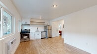 Located at 1725 Park Ave in the sought-after Silver Lake neighborhood of Los Angeles, this thoughtfully updated single-floor unit offers a clean, modern aesthetic throughout. Light wood-tone flooring runs continuously across the entire space, lending warmth and visual cohesion to every room.

The kitchen is a standout feature, outfitted with crisp white shaker cabinetry, open floating shelves, and a full suite of stainless steel appliances — including a gas range, dishwasher, and refrigerator. A matte black faucet over a stainless sink adds a contemporary finishing touch, while ample counter space supports everyday cooking needs.

The living area is bright and open, with multiple windows allowing natural light to fill the room. A wall-mounted air conditioning unit provides climate control, and the clean white walls create a versatile, move-in-ready canvas.

Additional rooms offer flexible use as a bedroom or dedicated workspace, maintaining the same bright, minimal character with recessed lighting and generous floor space.

The bathroom is finished with notable style, featuring a slatted wood vanity with a white basin, matte black fixtures, a rounded rectangular mirror, and a full soaking tub with white tile surround. A frosted window above the tub introduces natural light while preserving privacy. The overall design is cohesive, functional, and modern.