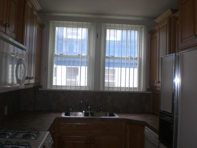 Kitchen windows lots of light and cabinetry - 18519 Chagrin Blvd