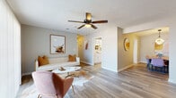 This two-bedroom, two-bathroom unit at Bradford Place in Byram, Mississippi delivers a thoughtfully designed single-floor layout with a warm, contemporary aesthetic throughout. The open living area features wood-look flooring, a ceiling fan with light fixture, and neutral wall tones that create a bright and welcoming atmosphere. The space flows naturally into a dedicated dining area, highlighted by a striking geometric pendant light above a live-edge wood dining table, with direct sightlines to the in-unit laundry room beyond.

The galley-style kitchen is outfitted with white cabinetry, light countertops, stainless steel appliances including an electric range and dishwasher, and a double basin sink — offering ample storage and functionality. Both bedrooms are carpeted and generously sized, featuring large windows that invite natural light and provide a comfortable, restful environment.

The two bathrooms echo the clean, neutral palette of the rest of the unit, each with wood-look flooring, white vanities, and shower/tub combinations. A dedicated in-unit laundry area accommodates a full-size washer and dryer with overhead shelving for additional storage. Bradford Place combines practical amenities with a cohesive modern design, making it a well-appointed residence in Byram, MS.