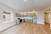 Located at 401 Union Ave SE in Olympia, Washington, this thoughtfully designed 2-bedroom, 1-bathroom residence offers a clean, modern aesthetic throughout its efficiently arranged single-floor layout. Light wood-tone flooring flows seamlessly through every room, creating a cohesive and bright atmosphere.

The open-concept kitchen and living area forms the heart of the home. The kitchen features sage-green cabinetry with upper glass-front accent cabinets, stainless steel appliances including a refrigerator, electric range, and dishwasher, and white countertops. Recessed lighting illuminates the space, while a window allows in natural light. The adjoining living area offers ample room for furnishings and opens into the hallway.

The hallways are clean and well-lit, with a standout sliding barn door adding a modern farmhouse touch. The primary bedroom is a comfortable size, featuring dual sliding-door closets for generous storage. The second bedroom benefits from a large window with a pleasant tree-lined outdoor view, filling the room with natural light. Four closets in total provide excellent storage throughout.

The bathroom is finished in crisp white, with a tub/shower combo and clean, simple fixtures. The overall design is neutral, bright, and move-in ready.