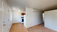 Located at 8435 SE Insley St in Portland, Oregon, this single-floor, 2-bedroom, 1-bathroom unit offers a practical and efficient layout. The open living area features a combination of hardwood-style flooring and carpet, with a textured ceiling and a ceiling fan providing comfort throughout. A wall-mounted ductless mini-split system ensures climate control year-round.

The kitchen is positioned off the main living area and is equipped with warm-toned wood cabinetry, a white refrigerator, an electric range with a range hood, and a standard flush-mount ceiling light. The galley-style layout makes efficient use of the available space.

The bedrooms are carpeted and brightly lit, with the spacious primary bedroom offering a notably generous footprint. Both rooms feature clean white walls, textured ceilings, and windows that allow natural light to filter in, offering views of the surrounding neighborhood.

The bathroom is appointed with tile-surround tub and shower combination, featuring a decorative mosaic accent border. Hardwood-style flooring, a standard toilet, and clean finishes round out the space.

A dedicated closet provides additional storage. The unit's straightforward, functional design makes it a practical option for those seeking a well-organized living space in Southeast Portland.