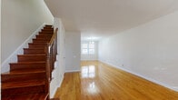 This 1-bedroom, 1-bathroom duplex at 73 Chester Circle in New Brunswick, NJ offers a thoughtfully laid-out two-floor design with a clean, bright aesthetic throughout. The main floor hosts the living room, dining room, and kitchen, all united by polished hardwood floors that reflect natural light beautifully. The open living and dining area is spacious and welcoming, anchored by a chandelier above the dining space and a large window that brings in natural light. A classic wood staircase with a rich banister adds character to the main level.

The kitchen is efficiently designed with warm honey-toned cabinetry, granite-style countertops, a tile backsplash, black appliances including a gas range and built-in microwave, and light tile flooring. A pass-through window connects the kitchen to the living area, enhancing the open feel.

Upstairs, the generously sized bedroom features gleaming hardwood floors, a ceiling fan, two windows with natural light, and direct access to a large closet. The full bathroom is well-appointed with beige tile flooring and walls, a tub/shower combination with decorative tile accents, and a wood-toned vanity. With four closets total throughout the home, storage is plentiful. The duplex offers a practical and comfortable layout well-suited for everyday living.