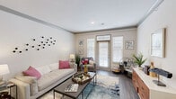 Located at 12601 Charles Farm Cir in Louisville, KY, this single-floor, 2-bedroom, 1-bathroom home offers a thoughtfully designed layout with modern finishes throughout. The living room serves as a bright, welcoming centerpiece, featuring wood-style flooring, neutral walls with gray crown molding, and large windows with transom details that invite generous natural light. The kitchen is outfitted with white cabinetry, stainless steel appliances including a refrigerator, microwave, and range, and offers a clean, efficient workspace. A connecting hallway leads to both bedrooms and the bathroom, maintaining a smooth flow through the home. The spacious primary bedroom features plush carpeting and a large window dressed with blinds and curtains, creating a comfortable retreat. The bathroom presents a granite-topped vanity with white cabinetry and a large mirror, complemented by wood-style flooring. A dedicated walk-in closet provides practical storage with wire shelving and hanging rods. The home also includes an attached garage with direct interior access, an electrical panel, and an automatic opener, adding convenience and utility to this well-rounded residential space.