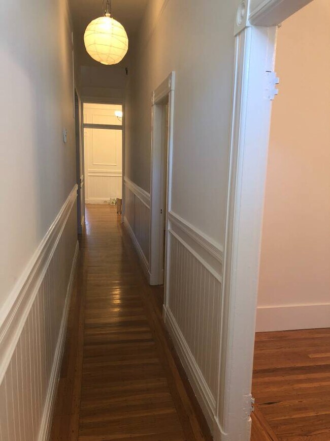 It is a railroad flat with a long hallway. - 941 Capp St