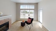 Located in Renton, Washington, Unit A314 at 232 Burnett Ave S is a single-floor residence designed with functionality and comfort in mind. The living area is bathed in natural light, courtesy of large windows dressed with vertical blinds, and offers direct access to an outdoor balcony through a sliding glass door — ideal for enjoying the surrounding Pacific Northwest scenery. The carpeted bedrooms are generously proportioned, each featuring windows with vertical blinds that allow for adjustable natural light, wall-mounted baseboard heating, and ceiling fans to ensure year-round comfort. Neutral-toned walls throughout the unit create a clean, versatile backdrop. The kitchen is well-appointed with white cabinetry offering ample storage, light countertops with tile backsplash, and white appliances including a range, over-the-range microwave, and dishwasher. Tile flooring in the kitchen provides durability and easy maintenance. The overall floor plan, as seen in the dollhouse view, reflects a practical and open layout connecting the living, kitchen, and bedroom spaces seamlessly. This unit offers a bright, move-in-ready living environment in a convenient Renton location.