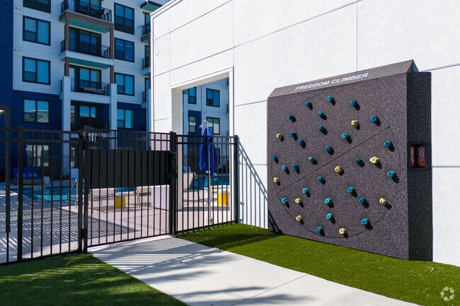 Reach new heights with our outdoor climbing wall! - The Reef Apartments