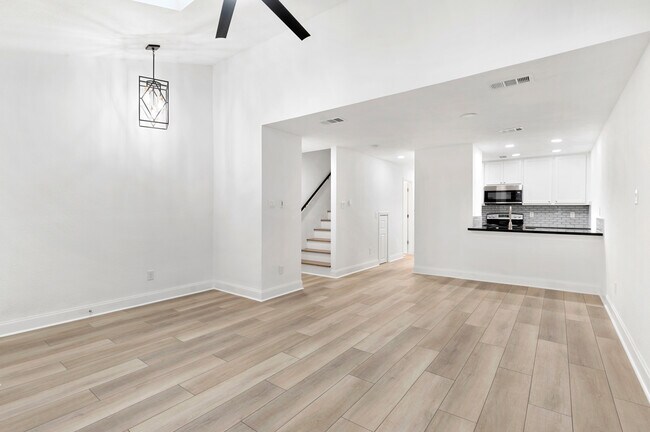 Living room is open to the dining room and kitchen. Notice the additional bar-height seating. - 1501 Stallings Dr
