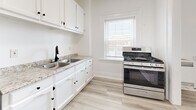 Located at 1501 W Adams Blvd in Los Angeles, CA, this efficient one-bedroom, one-bathroom unit offers a well-organized layout across a single floor. Light wood-style flooring runs throughout the space, creating a clean, cohesive look that enhances the bright, airy atmosphere.

The bedroom is a comfortable, well-proportioned room featuring two windows that invite generous natural light and offer street views. A ceiling fan adds practical comfort, and crisp white walls keep the space feeling open.

The kitchen is thoughtfully appointed with white shaker-style cabinetry, granite-look countertops, a double-basin sink with a matte black faucet, and stainless steel appliances including a gas range and refrigerator. A window above the counter provides additional natural light, making the space pleasant for cooking and meal prep.

A hallway connects the main rooms and provides access to a dedicated closet for storage. The bathroom features a tiled walk-in shower and matches the clean, minimal aesthetic of the rest of the unit.

Overall, the space presents a bright, move-in-ready interior with consistent finishes, practical storage, and a straightforward layout — well-suited for those seeking a functional and low-maintenance home in central Los Angeles.