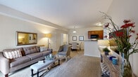 Located at 4901 Warner Rd in Columbus, Ohio, this single-floor residence offers a well-designed layout that balances comfort and functionality. The entry opens into a spacious, open-concept living and dining area finished with plush wall-to-wall carpeting and neutral warm tones. Large sliding glass doors fitted with vertical blinds allow generous natural light to fill the living room, creating a bright and welcoming atmosphere. The dining area flows seamlessly from the living space, anchored by a pendant light overhead.

The galley-style kitchen is efficiently designed with rich warm-toned cabinetry, granite-look countertops, hardwood flooring, and a full suite of black appliances including a refrigerator, electric range, microwave, and dishwasher. A double-basin sink completes the workspace.

The residence includes multiple bedrooms, each carpeted and finished with neutral walls. Bedrooms feature closets with sliding doors, natural light from windows with blinds, and comfortable proportions. The primary bathroom features tile flooring, a warm wood vanity with granite-look counters, and ample lighting. A second full bathroom mirrors the same finishes, offering a tub-shower combination. The overall ambiance is clean, cohesive, and move-in ready.